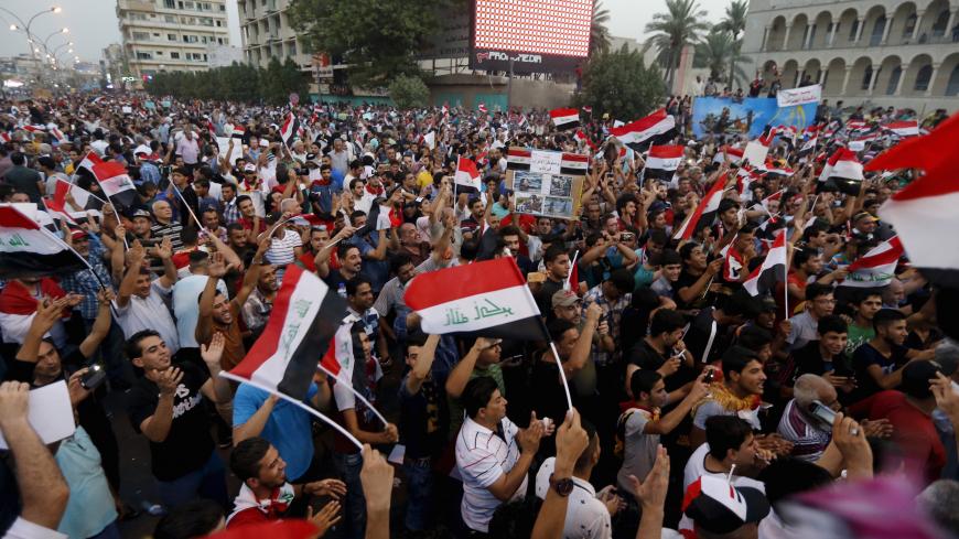 Iraqi people shout slogans during a demonstration against the poor quality of basic services, power outages and calling for trial of corrupt politicians in Baghdad, Iraq, August 28, 2015. Iraqi Prime Minister Haider al-Abadi on Friday ordered security forces to ease access to Baghdad's fortified Green Zone and main streets, in an apparent bid to improve daily life for ordinary Iraqis as fresh protests erupted across the country. Tens of thousands of demonstrators filled Baghdad's Tahrir Square on Friday in 