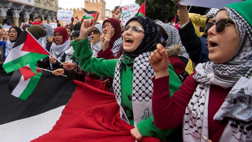 Pro-Palestinian protesters wave Palestinian flags and chant slogans against the US and Israel on December 10, 2017 during a demonstration in Rabat against US President Donald Trump's declaration of Jerusalem as Israel's capital.  / AFP PHOTO / FADEL SENNA        (Photo credit should read FADEL SENNA/AFP/Getty Images)
