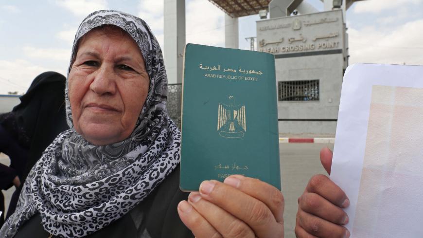 A Palestinian woman holds her passport during a rally at the Rafah border crossing between Egypt and Gaza calling on Egypt to open the crossing, in the southern Gaza Strip on July 6, 2017.
Hamas leader Ismail Haniya said recent talks in Egypt could lead to improving the humanitarian suffering in the impoverished Gaza Strip. / AFP PHOTO / SAID KHATIB        (Photo credit should read SAID KHATIB/AFP/Getty Images)