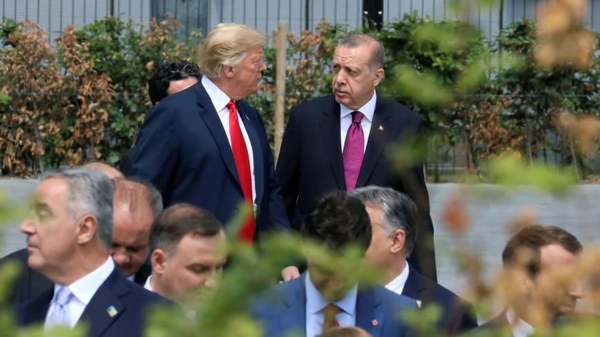U.S. President Donald Trump and Turkish President Tayyip Erdogan speak at the start of the NATO summit in Brussels, Belgium July 11, 2018.   REUTERS/Reinhard Krause - RC1E8AE4CB40