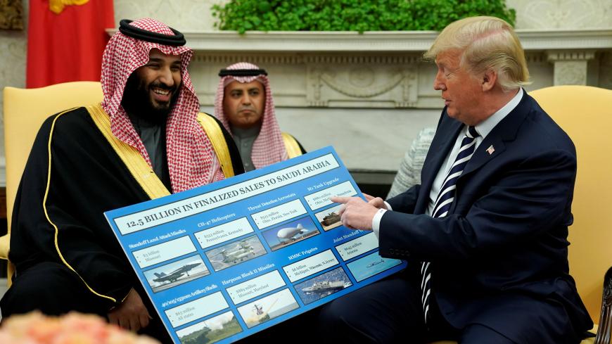 U.S. President Donald Trump holds a chart of military hardware sales as he welcomes Saudi Arabia's Crown Prince Mohammed bin Salman in the Oval Office at the White House in Washington, U.S., March 20, 2018.  REUTERS/Jonathan Ernst - RC1D275A0090