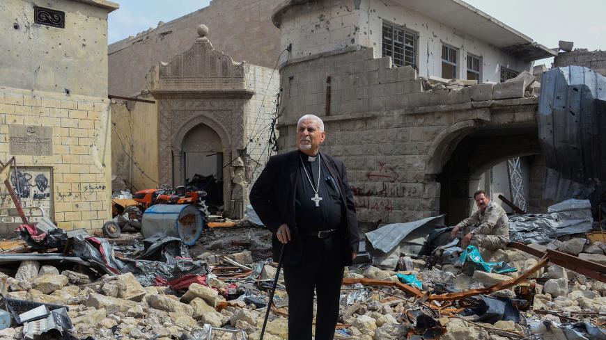 Father John Botros Moshi, the Syriac Catholic Archbishop of Mosul, Kirkuk, and the Kurdistan Region, stands in the rubbles of the Tahra church in Mosul on April 29, 2018. - The church, established during the seventh century, was destroyed by bombings when the regime was fighting jihadists in this area. A French charity called "Brotherhood in Iraq", pledges to rebuild it. (Photo by Zaid AL-OBEIDI / AFP)        (Photo credit should read ZAID AL-OBEIDI/AFP/Getty Images)