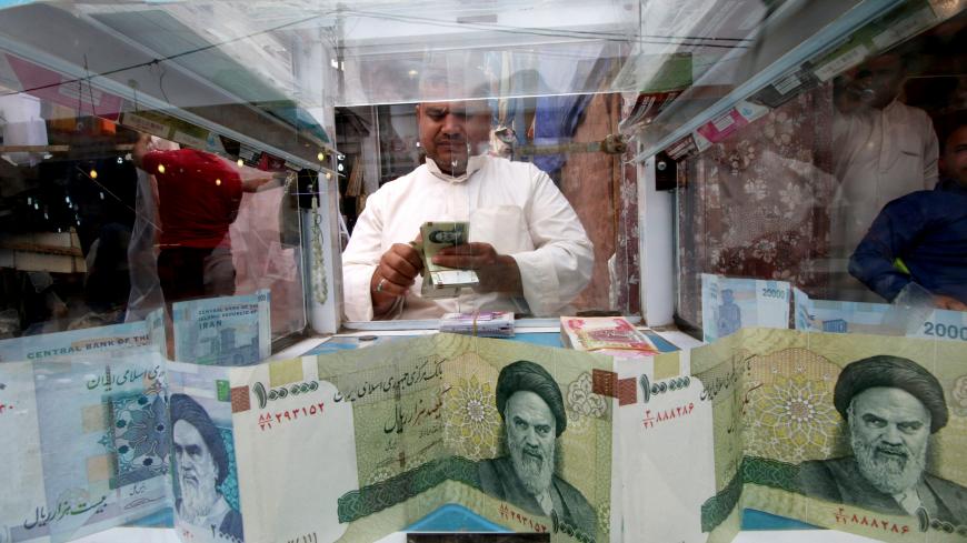 A man counts Iranian rials at a currency exchange shop, before the start of the U.S. sanctions on Tehran, in Basra, Iraq November 3, 2018. Picture taken November 3, 2018. REUTERS/Essam al-Sudani - RC153985B7A0