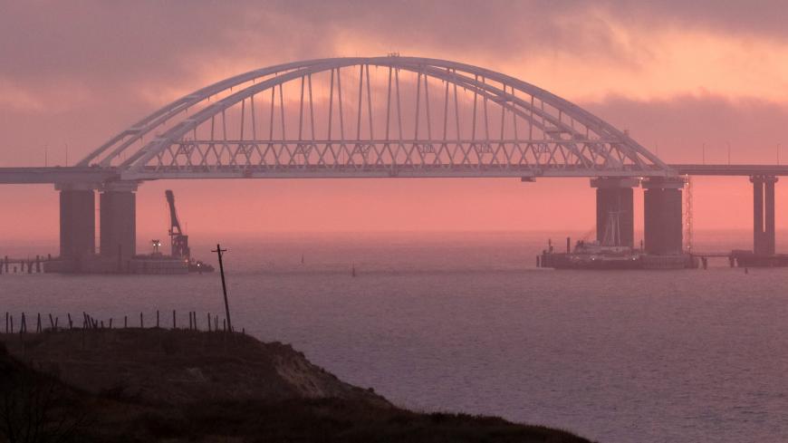 A general view shows a road-and-rail bridge, which is constructed to connect the Russian mainland with the Crimean peninsula, at sunrise in the Kerch Strait, Crimea November 26, 2018. REUTERS/Pavel Rebrov - RC1C9CFF8770