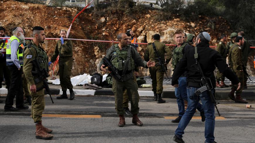 Israeli forces are seen at the scene of a shooting attack near Ramallah in the Israeli-occupied West Bank December 13, 2018. REUTERS/Ammar Awad - RC15A3F7D480