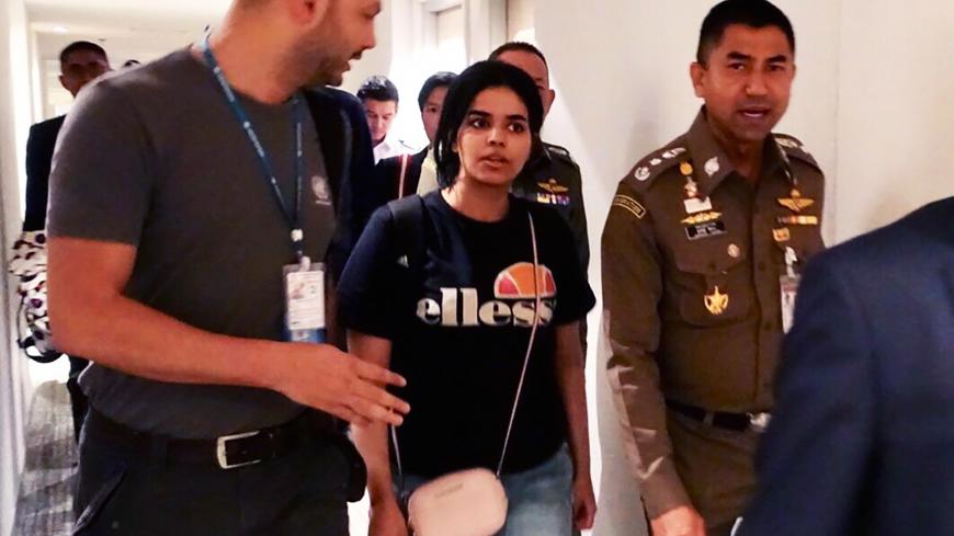 This handout picture taken and released by Thai Immigration Bureau on January 7, 2019 shows 18-year-old Saudi woman Rahaf Mohammed al-Qanun (2nd-L) is being escorted by the Thai immigration officer and United Nations High Commissioner for Refugees (UNHCR) officials at the Suvarnabhumi international airport in Bangkok. - Rahaf Mohammed al-Qunun, seeking asylum has left Bangkok airport "under the care" of the UN refugee agency, a Thai official said Monday, following her desperate plea against deportation. (Ph