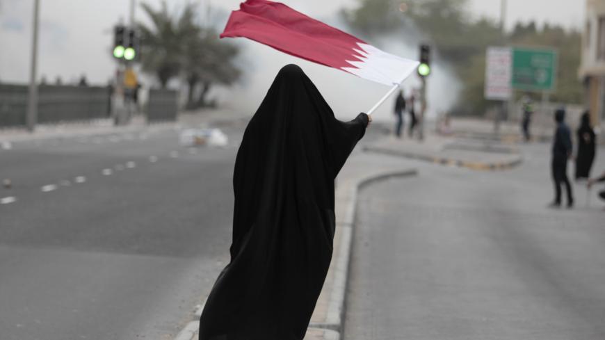 A female protester waves Bahrain's flag as she takes part in a protest marking the 4th anniversary of the 14th February uprising to demand democratic reforms in the village of Sanabis, west of Manama, February 14, 2015.
Bahrain quelled the 2011 uprising but has since struggle to resolve political deadlock between the government and the Shi'ite opposition. Sporadic unrest has continued. REUTERS/Hamad I Mohammed  (BAHRAIN - Tags: POLITICS CIVIL UNREST CRIME LAW) - GM1EB2F00KJ01