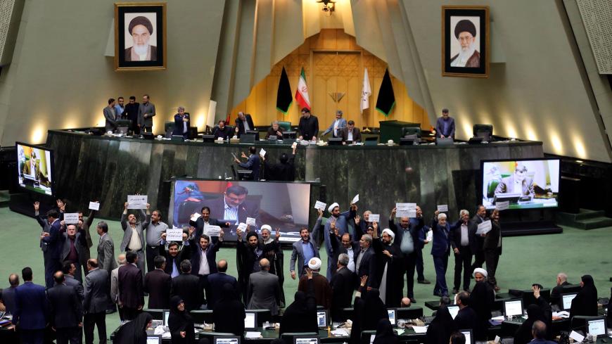 Iranian MP's display their disagreement over the a bill to counter terrorist financing in parliament in Tehran on October 7, 2018. - The bill, one of four put forward by the government to meet demands set by the international Financial Action Task Force (FATF), was passed by 143 votes to 120, according to the semi-official ISNA news agency. (Photo by ATTA KENARE / AFP)        (Photo credit should read ATTA KENARE/AFP/Getty Images)