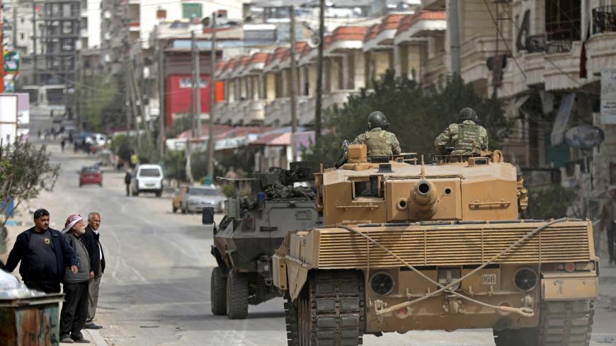 Turkish forces patrol an area in Afrin, Syria March 22, 2018. REUTERS/ Khalil Ashawi - RC19CBF8C260