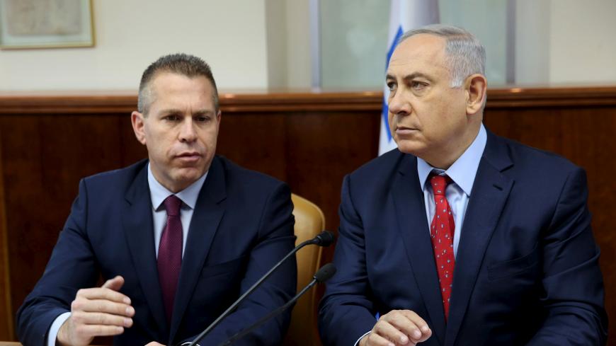 FILE PHOTO: Israeli Prime Minister Benjamin Netanyahu (R) sits next to Israeli Public security Minister Gilad Erdan during the weekly cabinet meeting in Jerusalem April 10, 2016. REUTERS/Gali Tibbon/Pool/File photo - RC17175E03C0