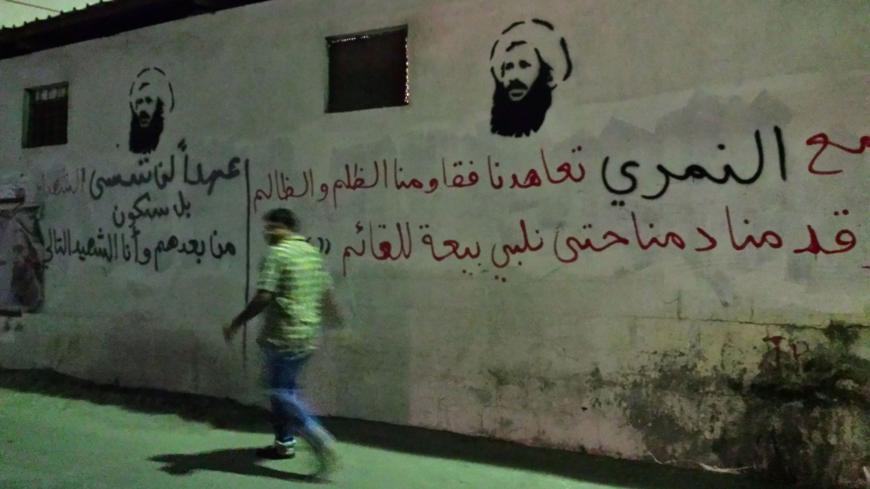 An undated picture taken in 2016 shows a man walking past images of executed Shiite cleric Nimr al-Nimr on a wall in the Awamiya area in Saudi Arabia's Eastern province.

In a Sunni-majority kingdom where banners of King Salman, his crown prince and deputy crown prince are widely displayed, the homage paid to Nimr is unusual and provocative.

 / AFP / STRINGER        (Photo credit should read STRINGER/AFP/Getty Images)