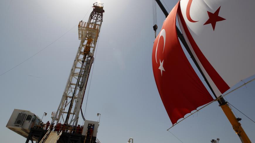 Turkish and Turkish Cypriot flags wave next to a drilling tower 25 km (16 miles) from Famagusta April 26, 2012. Turkish Cypriot Leader Dervis Eroglu and Turkey's Energy Minister Taner Yildiz attended a ceremony marking the start of joint gas and oil exploration works in northern Cyprus between Turkey's state-owned energy company TPAO and the Turkish-Cypriot administration. REUTERS/Umit Bektas (CYPRUS - Tags: POLITICS ENERGY BUSINESS) - GM1E84Q1HIQ01
