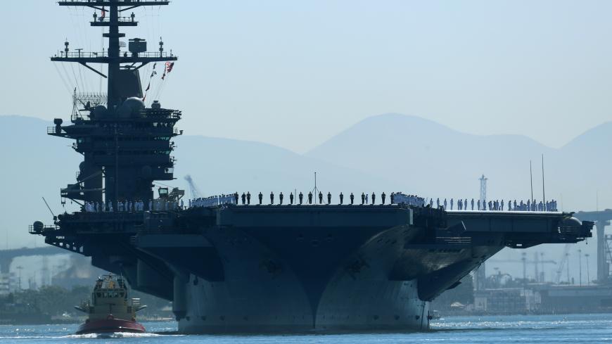 The aircraft carrier USS Theodore Roosevelt, with sailors manning the rails, leaves port on deployment to the western Pacific Ocean and Persian Gulf from San Diego, California, U.S., October 6, 2017.       REUTERS/Mike Blake - RC14B47C0D50
