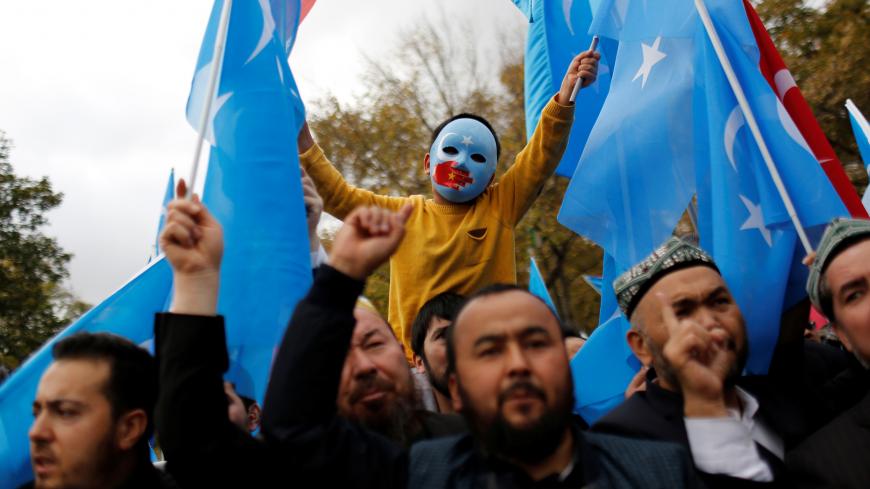 A masked Uighur boy takes part in a protest against China, at the courtyard of Fatih Mosque, a common meeting place for pro-Islamist demonstrators in Istanbul, Turkey, November 6, 2018. REUTERS/Murad Sezer  SEARCH "SEZER NOURMUHAMMED" FOR THIS STORY. SEARCH "WIDER IMAGE" FOR ALL STORIES. TPX IMAGES OF THE DAY. - RC1EFCCF5820