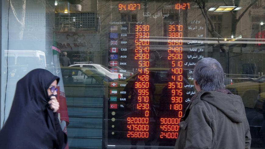 A man looks at exchange rates seen through the window of a currency exchange shop in Tehran's business district, Iran, January 17, 2016. REUTERS/Raheb Homavandi/TIMA ATTENTION EDITORS - THIS IMAGE WAS PROVIDED BY A THIRD PARTY. FOR EDITORIAL USE ONLY.  - GF20000097685