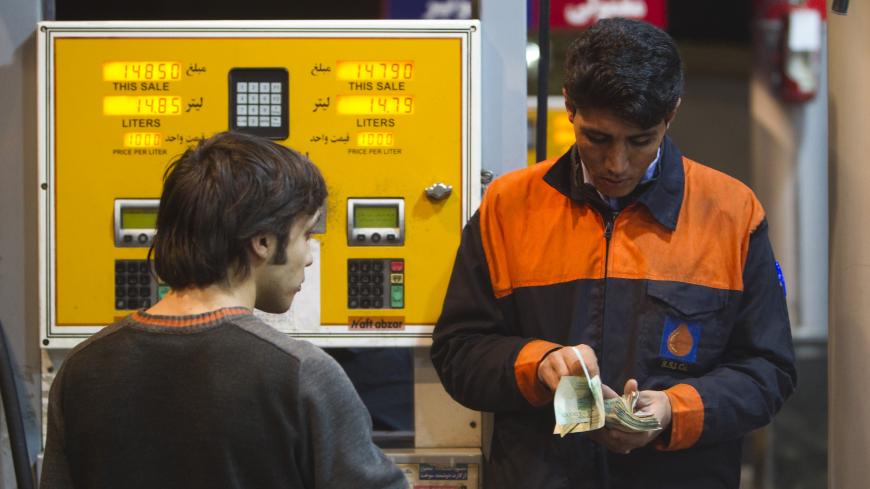 EDITORS' NOTE: Reuters and other foreign media are subject to Iranian restrictions on their ability to film or take pictures in Tehran. 

A petrol station attendant (R) counts money as a man waits for his change at a petrol station in northwestern Tehran December 19, 2010. The price of gasoline will rise four-fold in Iran in the coming days, state television announced late on Saturday, as the most politically sensitive part of President Mahmoud Ahmadinejad's subsidy cuts plan takes effect.  REUTERS/Morteza 