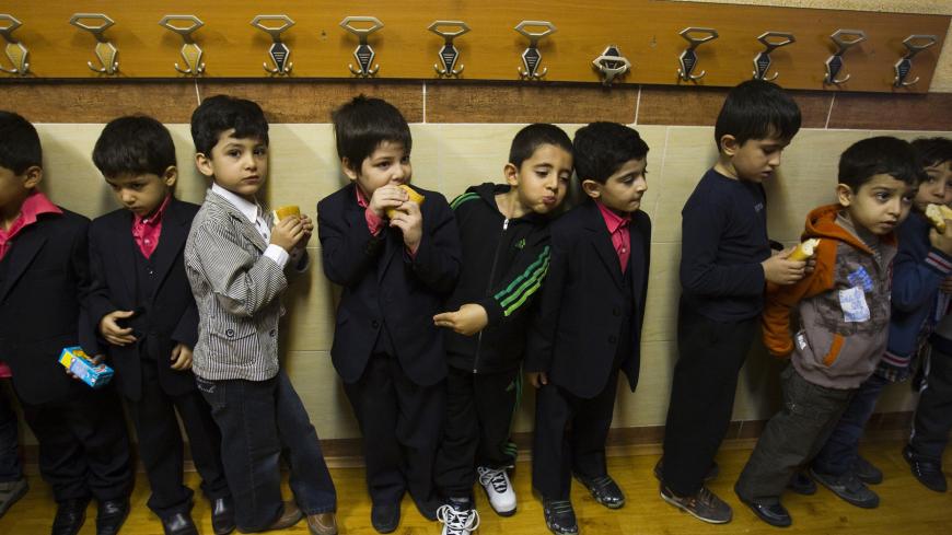 EDITORS' NOTE: Reuters and other foreign media are subject to Iranian restrictions on leaving the office to report, film or take pictures in Tehran.

Students line up to get their food at Pishtaz School in Tehran October 15, 2011. Pishtaz, the first computerised pre-school for gifted students in Iran, claims to have pioneered teaching techniques through the means of IT. Parents can watch their children's daily activities from home via CCTV cameras installed throughout the public areas in the school, which i