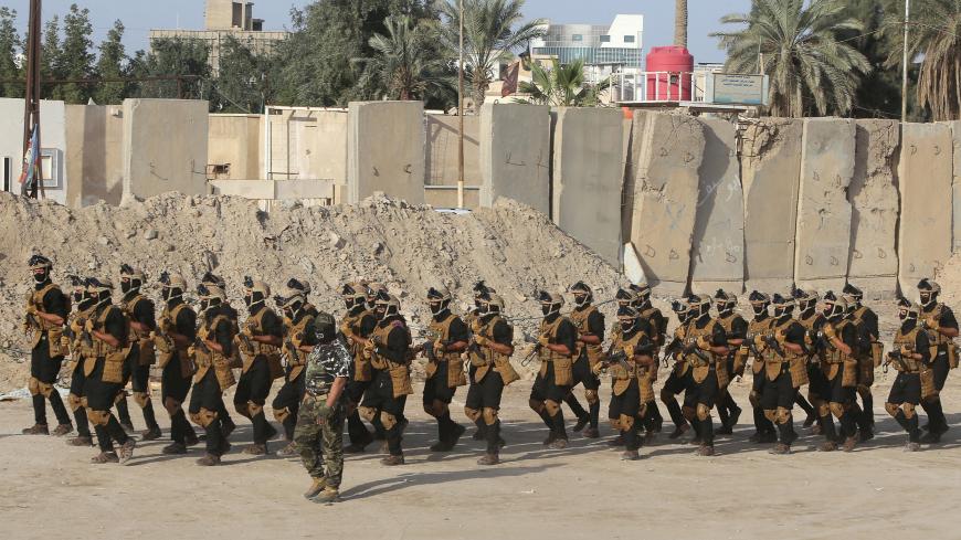 Members of Iraqi Popular Mobilization Forces (PMF) demonstrate their skills during a rehabilitation military exercise at a graduation ceremony in Basra, Iraq January 31, 2019. REUTERS/Essam al-Sudani - RC1DDE9A9E60