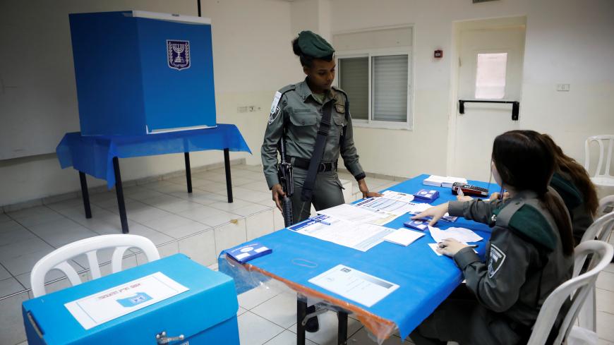 An Israeli border policewoman prepares to vote in national elections a day before polling stations open in the rest of Israel, at a base in Beit Horon settlement in the Israeli-occupied West Bank April 8, 2019. REUTERS/Nir Elias - RC11A8A38230