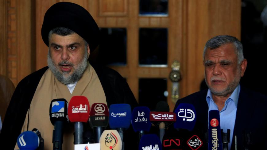Iraqi Shi'ite cleric Moqtada al-Sadr speaks during a news conference with Leader of the Conquest Coalition and the Iran-backed Shi'ite militia Badr Organisation Hadi al-Amiri, in Najaf, Iraq June 12, 2018. REUTERS/Alaa al-Marjani - RC1820CC66C0