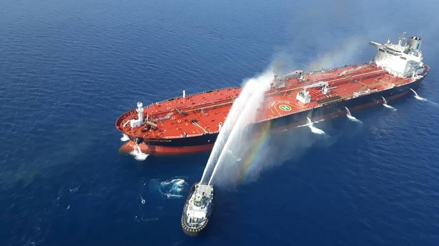 An Iranian navy boat tries to stop the fire of an oil tanker after it was attacked in the Gulf of Oman, June 13, 2019. Tasnim News Agency/Handout via REUTERS ATTENTION EDITORS - THIS IMAGE WAS PROVIDED BY A THIRD PARTY. - RC1D5E81AD00