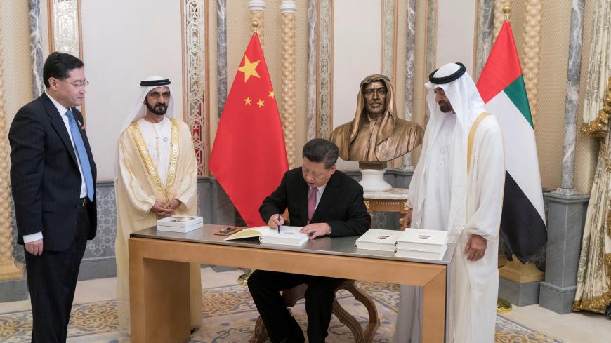 Chinese President Xi Jinping signs a book during the presence of the Prime Minister and Vice President of the United Arab Emirates and Ruler of Dubai Sheikh Mohammed bin Rashed al-Maktoum  and Abu Dhabi's Crown Prince Sheikh Mohammed bin Zayed al-Nahyan at the Presidential Palace in Abu Dhabi, United Arab Emirates July 20, 2018. WAM/Handout via REUTERS.  ATTENTION EDITORS - THIS IMAGE WAS PROVIDED BY A THIRD PARTY. - RC1FC6481370