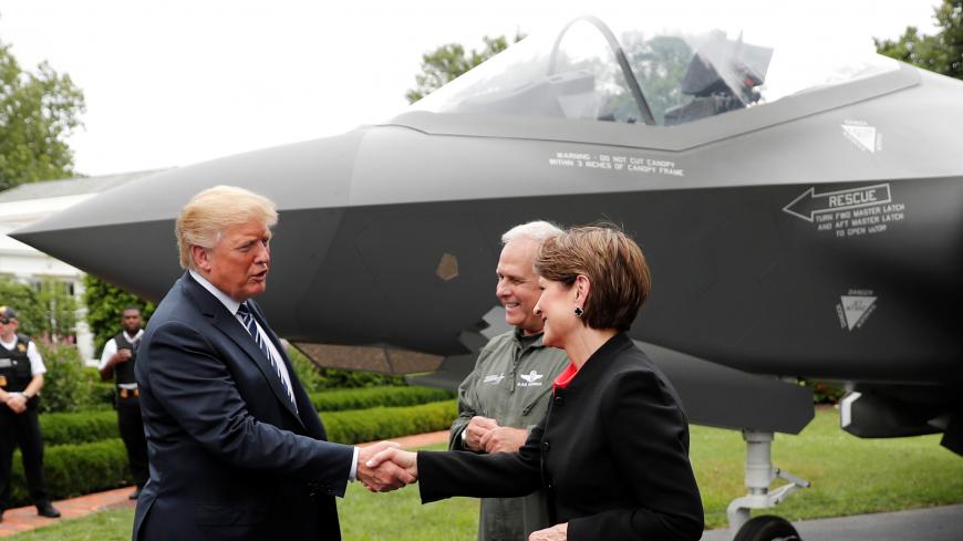 U.S. President Donald Trump greets Lockheed Martin CEO Marillyn Hewson in front of a Lockheed Martin F-35 stealth fighter on the driveway abutting the South Lawn prior to delivering remarks at a showcase of American-made products event at the White House in Washington, U.S., July 23, 2018. REUTERS/Carlos Barria - RC130755D2D0