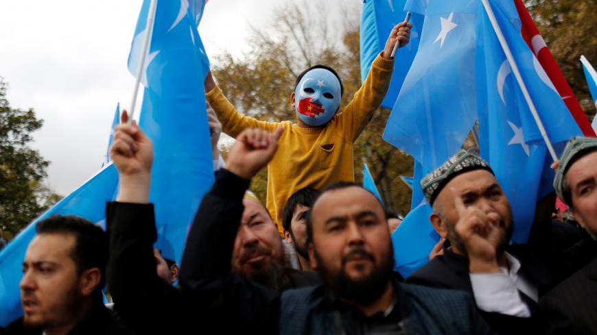 A masked Uighur boy takes part in a protest against China, at the courtyard of Fatih Mosque, a common meeting place for pro-Islamist demonstrators in Istanbul, Turkey, November 6, 2018. REUTERS/Murad Sezer  SEARCH "SEZER NOURMUHAMMED" FOR THIS STORY. SEARCH "WIDER IMAGE" FOR ALL STORIES. TPX IMAGES OF THE DAY. - RC1EFCCF5820