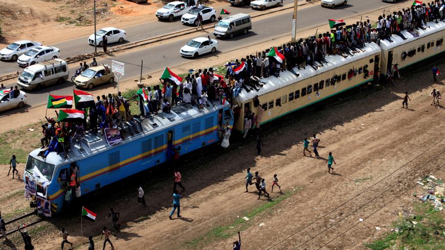 Sudanese civilians ride on the train to join in the celebrations of the signing of the Sudan's power sharing deal, that paves the way for a transitional government, and eventually elections, following the overthrow of long-time leader Omar al-Bashir in Khartoum, Sudan, August 17, 2019. REUTERS/Mohamed Nureldin Abdallah - RC1115D096E0