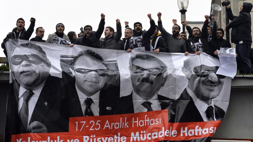 Supporters of main opposition Republican People's Party (CHP) hold a banner with pictures of four former ministers while shouting anti-government slogans during a protest in Ankara December 17, 2014. Main opposition CHP held an anti-government protest in Ankara on the first anniversary of the corruption probe, which became public with police raids on Dec. 17 last year, leading to the resignation of three ministers and prompted Erdogan to purge the state apparatus, reassigning thousands of police and hundred