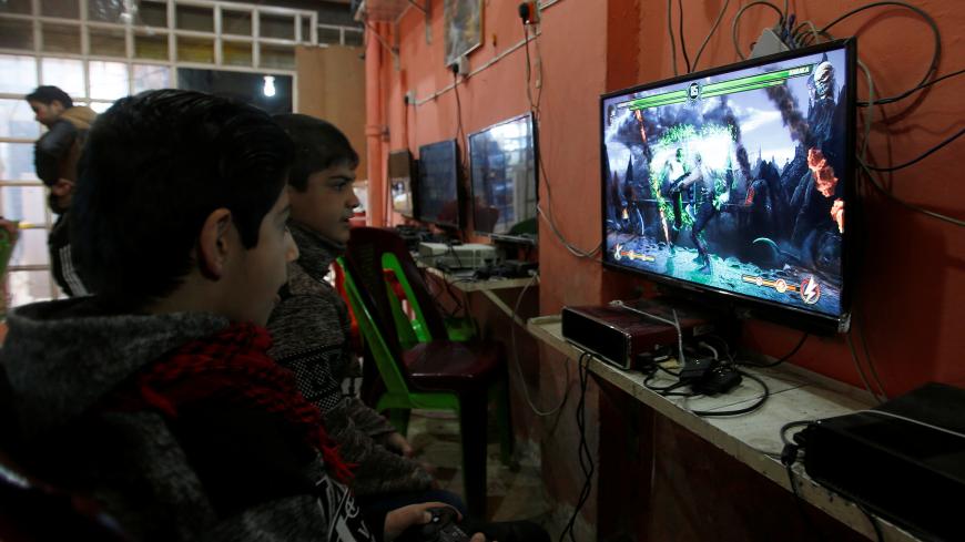 Boys play video games in Mosul, Iraq January 29, 2018.  REUTERS/Khalid Al-Mousily - RC168A0F0FF0