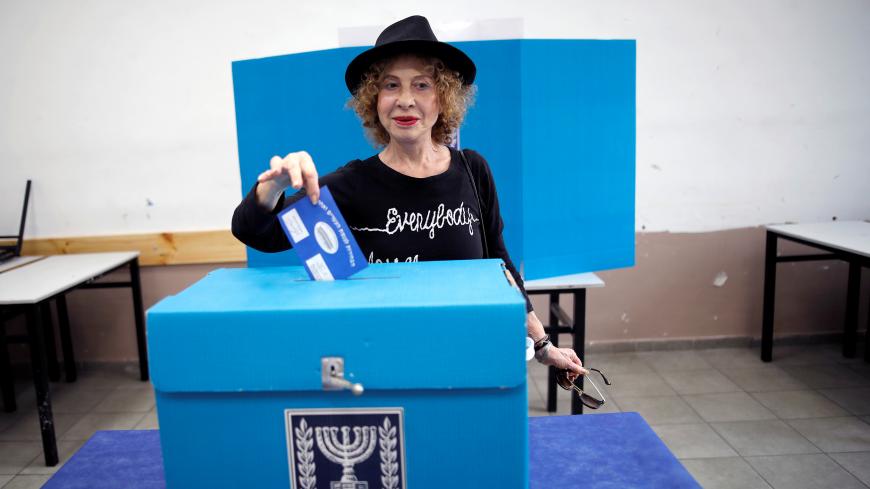A woman casts her ballot as Israelis vote in a parliamentary election, at a polling station in Tel Aviv, Israel April 9, 2019. REUTERS/Corinna Kern - RC140B7C35F0