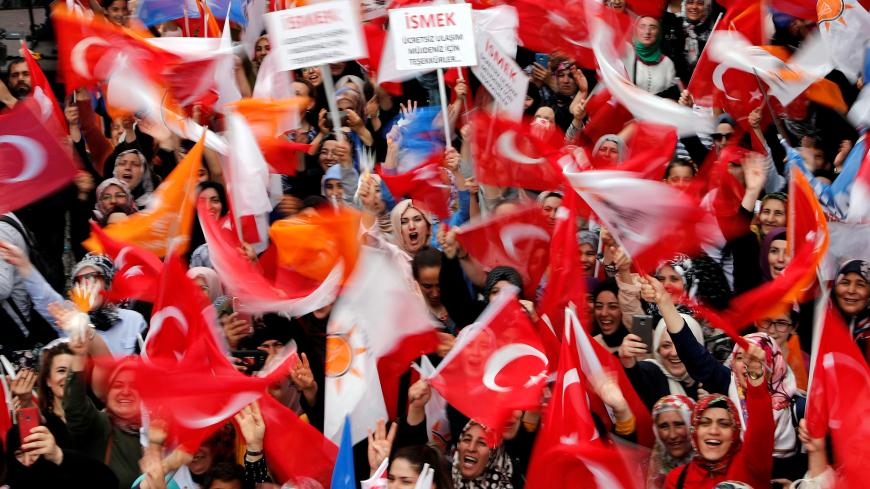 Supporters of the ruling AK Party (AKP) wave flags as their mayoral candidate Binali Yildirim speaks during an election rally in Istanbul, Turkey, June 21, 2019. REUTERS/Murad Sezer - RC17CE82D9C0