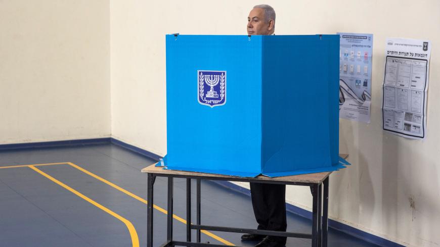 Israeli Prime Minister Benjamin Netanyahu stands behind a voting booth as he votes during Israel's parliamentary election at a polling station in Jerusalem September 17, 2019. Heidi Levine/Pool via REUTERS - RC1B8144FA90