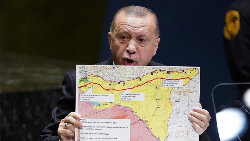 Turkey's President Recep Tayyip Erdogan holds up a map as he addresses the 74th session of the United Nations General Assembly at U.N. headquarters in New York City, New York, U.S., September 24, 2019. REUTERS/Carlo Allegri - HP1EF9O183U9F