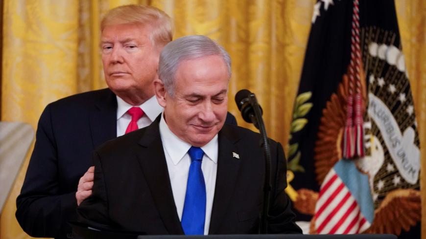 U.S. President Donald Trump puts his hands on Israel's Prime Minister Benjamin Netanyahu's shoulders as they deliver joint remarks on a Middle East peace plan proposal in the East Room of the White House in Washington, U.S., January 28, 2020. REUTERS/Joshua Roberts? - RC27PE95YQQU