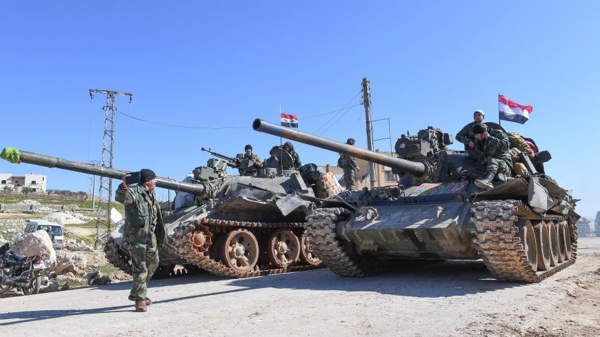 TOPSHOT - Syrian army units advance in the town of al-Eis in south Aleppo province on February 9, 2020, following battles with rebels and jihadists. - Al-Eis, which overlooks the M5, was on a front that saw fierce fighting between the regime and its opponents in 2016. Syrian troops advancing north of Idlib linked up near Al-Eis with their comrades pushing south of Aleppo, state news agency SANA said. The two units had recently waged separate battles in rural Aleppo and southern Idlib, but are now conjoined 