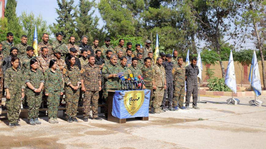 The Manbij Military Council members are seen during a news conference in Manbij, Syria June 6, 2018. REUTERS/Rodi Said - RC119372D1F0