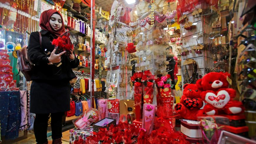 A woman searches for a gift for Valentine's Day at a gift shop in Mosul, Iraq February 13, 2019. Picture taken February 13, 2019. REUTERS/Khalid al-Mousily - RC18AACF06B0