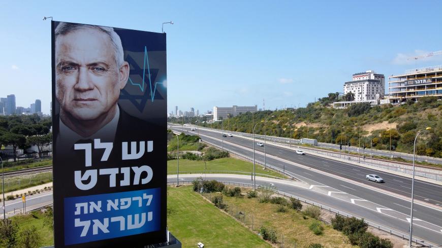 A billboard of Israeli Parliament speaker Benny Gantz is pictured along a highway in the Mediterranean costal city of Tel Aviv, on March 29, 2020. - Israeli Prime Minister Benjamin Netanyahu and his erstwhile rival Benny Gantz announced "significant progress" in talks towards forming an emergency unity government amid the novel coronavirus pandemic. (Photo by JACK GUEZ / AFP) (Photo by JACK GUEZ/AFP via Getty Images)
