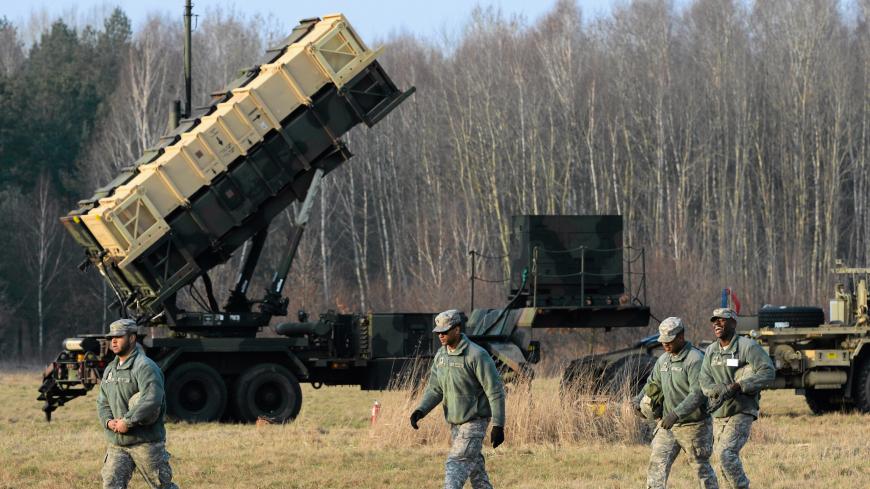 U.S soldiers walk next to  a Patriot missile defence battery during join exercises at the military grouds in Sochaczew, near Warsaw, March 21, 2015. The U.S. Army Europe has deployed a Patriot missile defence battery as part of joint exercises with Poland aimed at reassuring the NATO member in light of the conflict in neighbouring Ukraine. Picture taken March 21, 2015.   REUTERS/Franciszek Mazur/Agencja Gazeta  THIS IMAGE HAS BEEN SUPPLIED BY A THIRD PARTY. IT IS DISTRIBUTED, EXACTLY AS RECEIVED BY REUTERS,