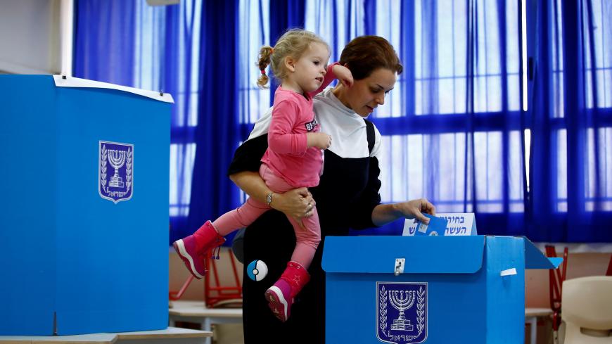 A woman casts her ballot as she votes in Israel's national election at a polling station in Tel Aviv, Israel March 2, 2020. REUTERS/Corinna Kern - RC2MBF9DATS2