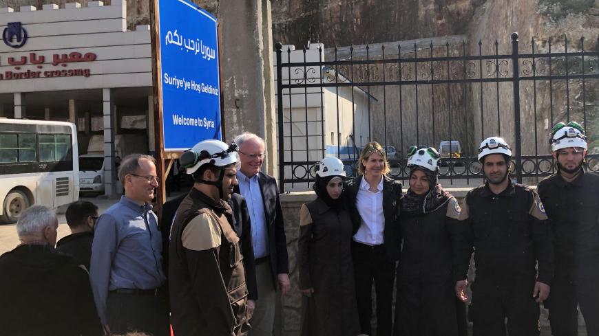 U.S. Ambassador to the United Nations Kelly Craft and James Jeffrey, the U.S. envoy for Syria, pose with rescue workers at the Syrian commercial crossing point of Bab al-Hawa opposite to Turkey's Cilvegozu border gate, in Idlib governorate, Syria, March 3, 2020. REUTERS/Tuvan Gumrukcu - RC2DCF9L6XKM