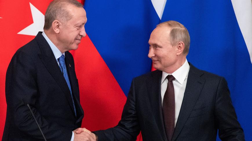Russian President Vladimir Putin and Turkish President Tayyip Erdogan shake hands during a news conference following their talks in Moscow, Russia March 5, 2020. Pavel Golovkin/Pool via REUTERS - RC2UDF91Q123
