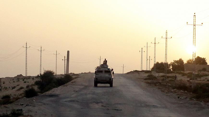 FILE PHOTO: An Egyptian military vehicle is seen on the highway in northern Sinai, Egypt, May 25, 2015.   To match Special Report EGYPT-POLITICS/SINAI      REUTERS/Asmaa Waguih/File Photo - RC17BB4CC790