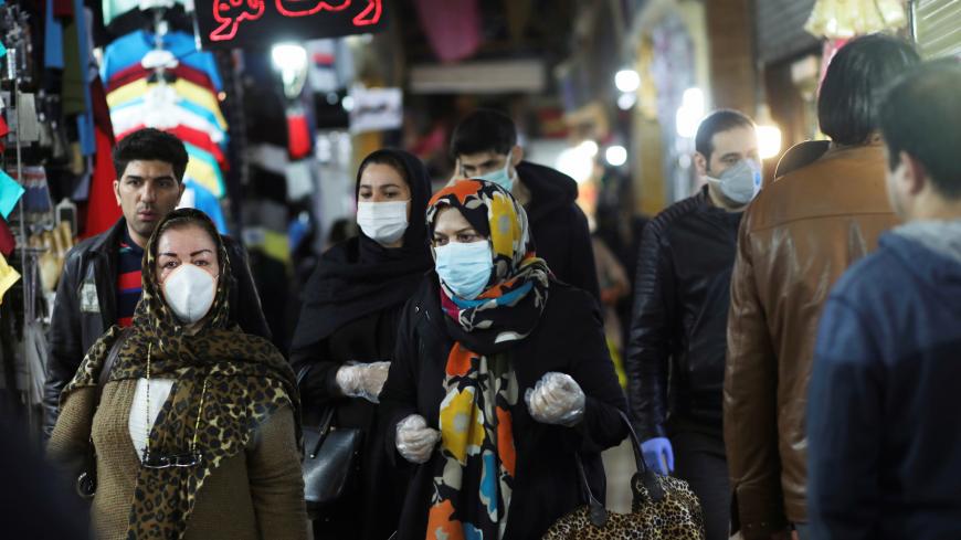 People wear protective face masks and gloves, amid fear of coronavirus disease (COVID-19), as they walk at Tajrish market, ahead of the Iranian New Year Nowruz, March 20, in Tehran, Iran March 18, 2020. Picture taken March 18, 2020. WANA (West Asia News Agency)/Ali Khara via REUTERS ATTENTION EDITORS - THIS PICTURE WAS PROVIDED BY A THIRD PARTY - RC22NF92HAWR