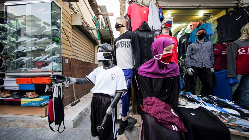 A vendor sells protective face masks and clothes, following the outbreak of coronavirus disease (COVID-19), in Manama, Bahrain, March 26, 2020. REUTERS/Hamad I Mohammed - RC2TRF9D6WE8