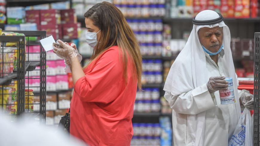 KUWAIT CITY, KUWAIT - APRIL 23: Citizens, wearing masks to prevent against the novel coronavirus (Covid-19) pandemic, arrive at Al-Mubarakiya bazaar for shopping ahead of the holy month of Ramadan, in Kuwait City, Kuwait on April 23, 2020. (Photo by Jaber Abdulkhaleg/Anadolu Agency via Getty Images)