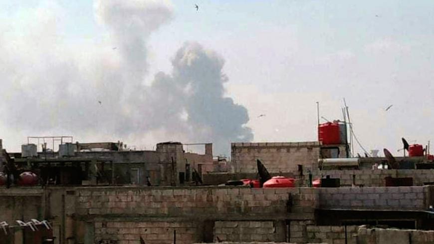A handout picture released by the official Syrian Arab News Agency (SANA) on May 1, 2020, shows smoke billowing above buildings in Syria's central city of Homs. - SANA said that the explosions ringing out of a Syrian army position in Homs resulted from a "human error during the transport of some ammunition, which led to human and material losses", while the Syrian Observatory for Human Rights, a Britain-based war monitor relying on sources inside Syria, said Israeli air strikes hit a missile depot belonging