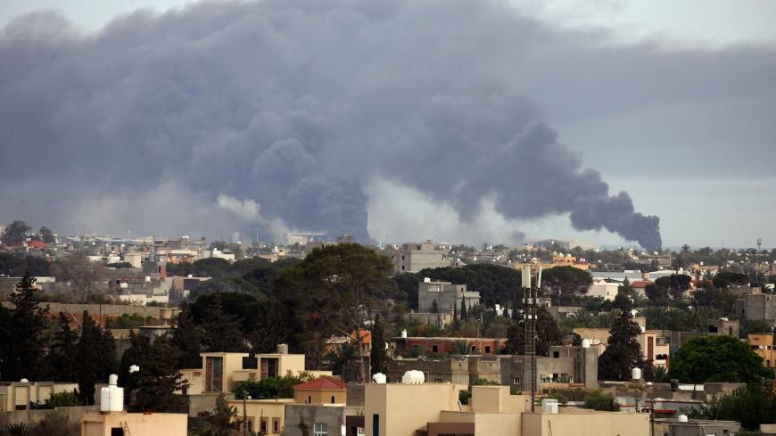 Smoke fumes rise above buildings in the Libyan capital Tripoli, during reported shelling by strongman Khalifa Haftar's forces, on May 9, 2020 (Photo by Mahmud TURKIA / AFP) (Photo by MAHMUD TURKIA/AFP via Getty Images)